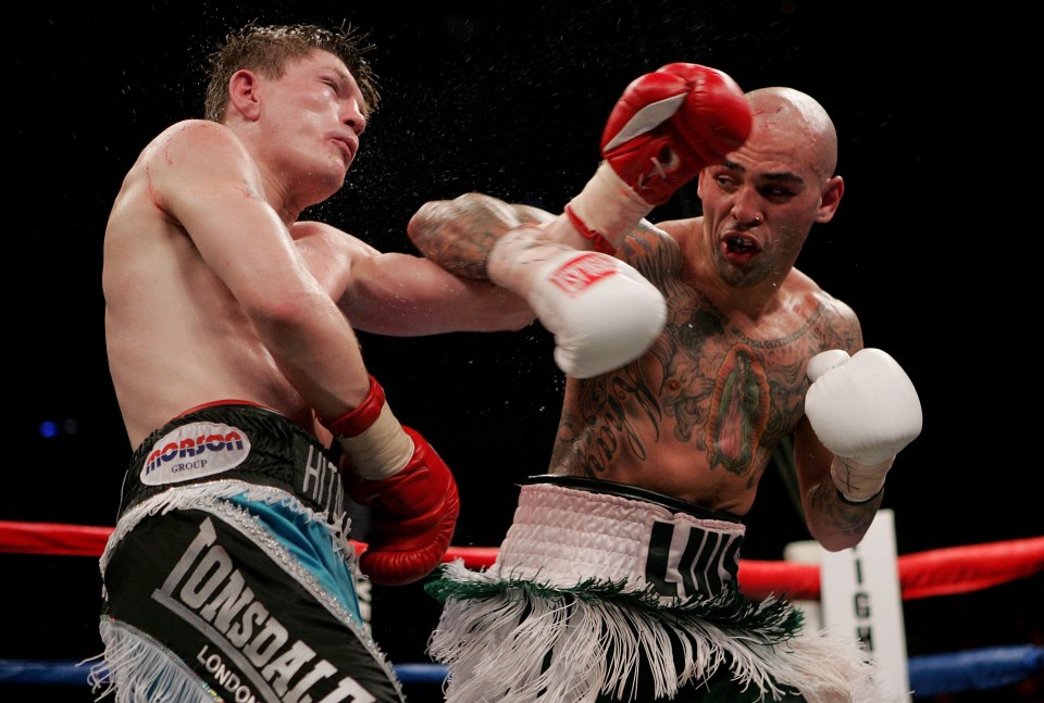 Two boxers exchanging blows in a boxing match.