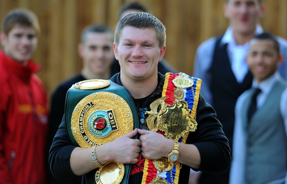 Ricky Hatton holding his boxing championship belts.