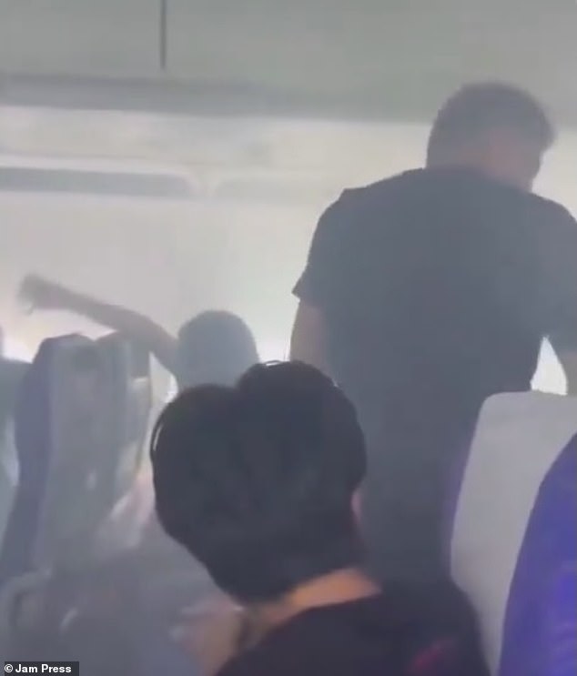 Similar scenes broke out on a plane in June when a cabin filled with smoke due to a power bank exploding just 15 minutes into a flight, as shown in the photograph above