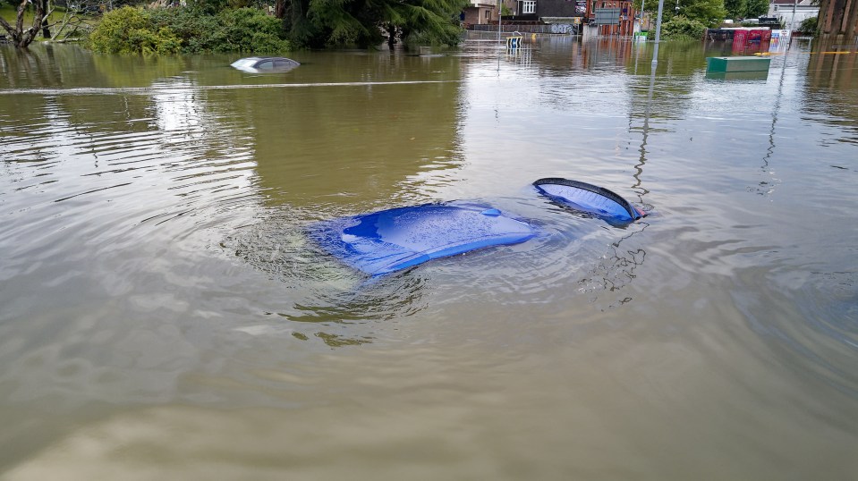 Submerged car in floodwaters.