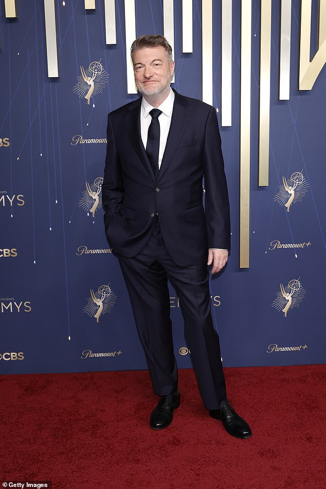 Charlie Brooker sported a dark suit and tie
