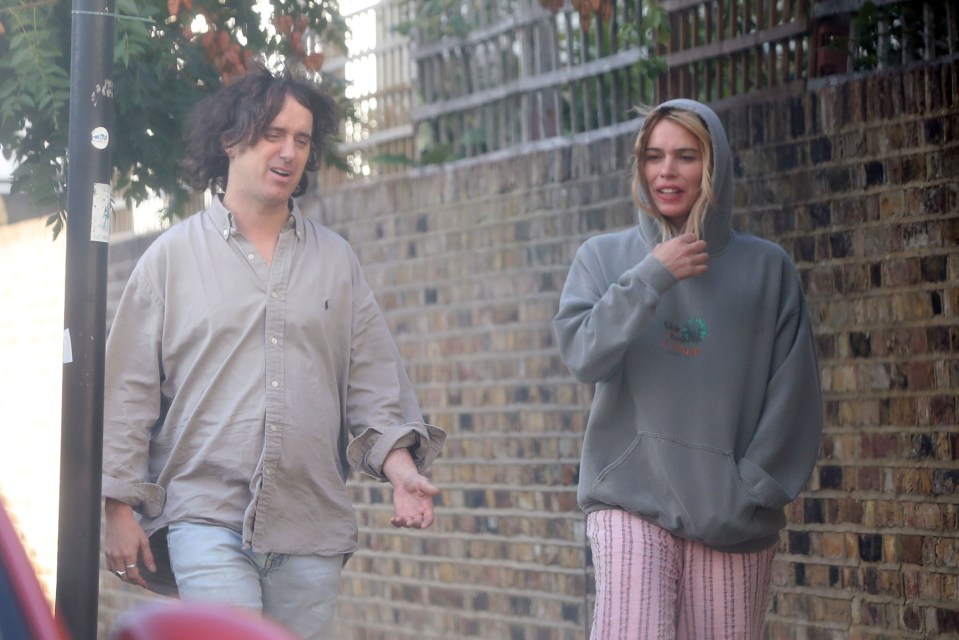 Billie Piper and Johnny Lloyd walking down the street.