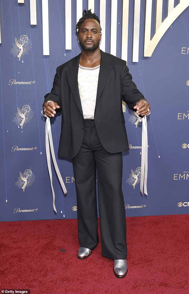 He paired the blazer with a white floral vest, wide-leg trousers and a pair of silver shoes
