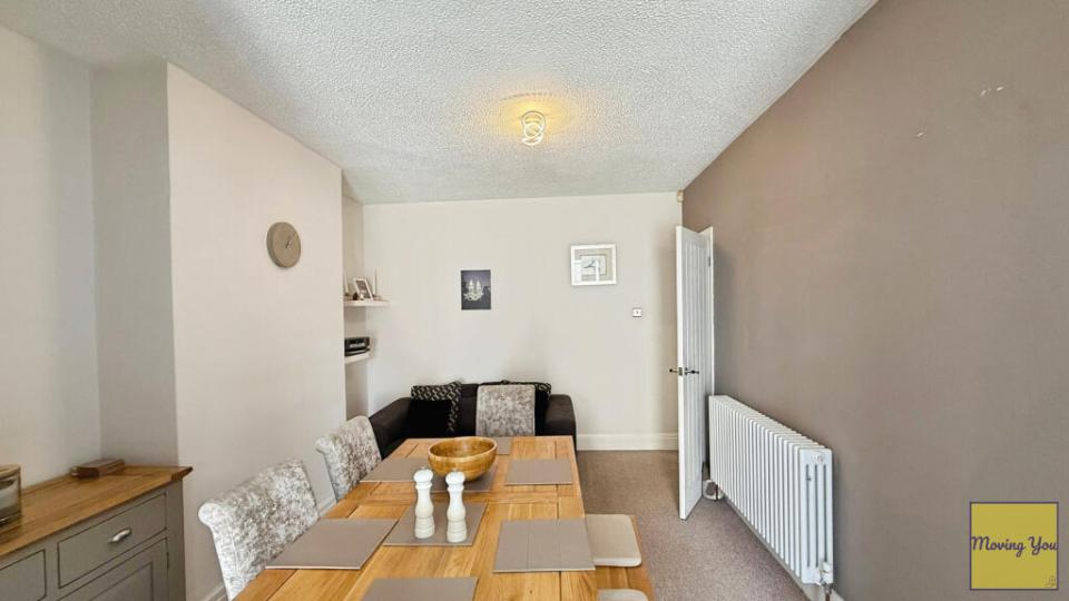 Dining room with wooden table and chairs.