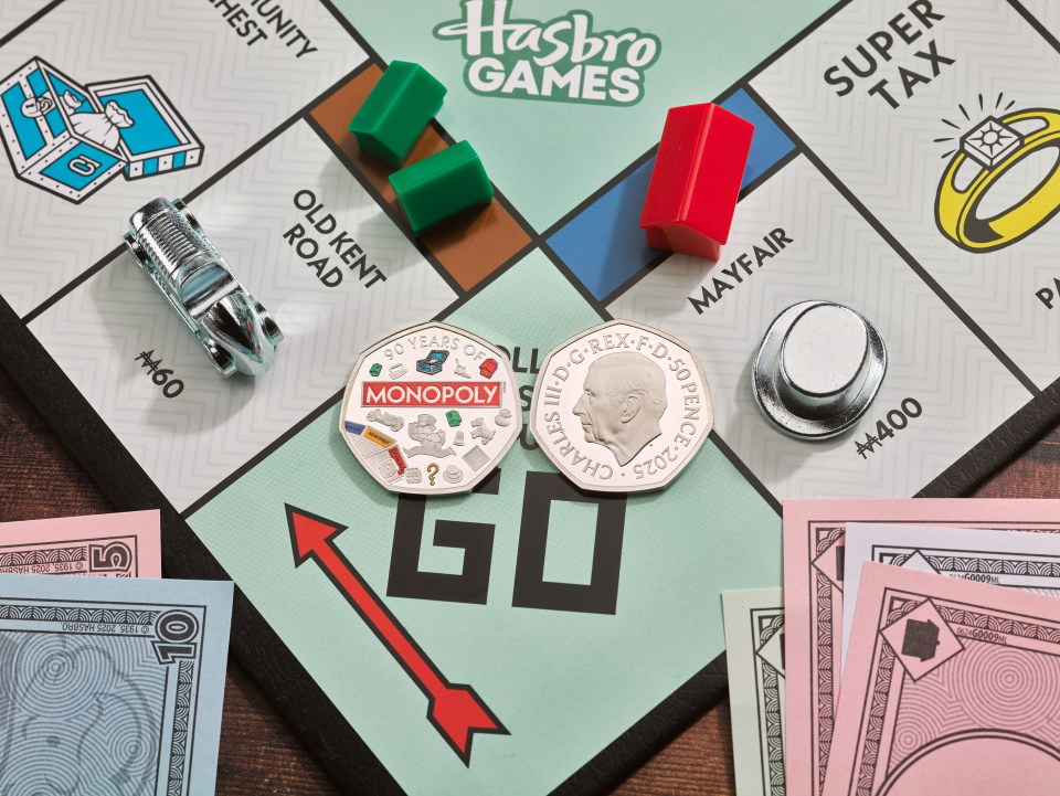 Monopoly 50p coin on a Monopoly board game.