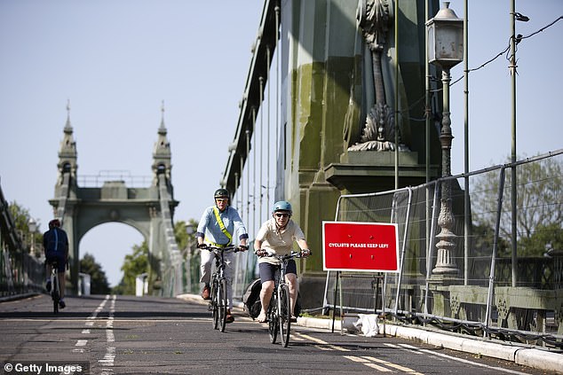 The bridge has remained closed to motor traffic for six years, a period spanning five prime ministers. Pictured: Cyclists riding over the bridge in July 2021