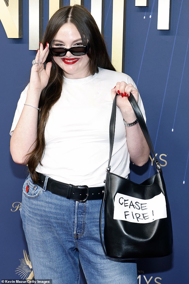 Comic Megan Stalter, 35, had the phrase 'Cease Fire!' written on her purse on the red carpet