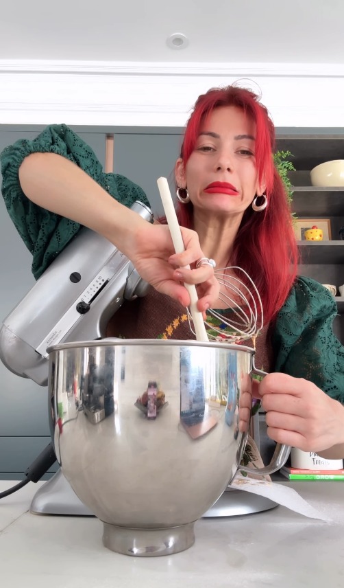 Woman using a stand mixer.