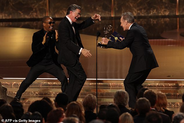 Colbert is pictured taking the stage in the moments after his show's win was announced