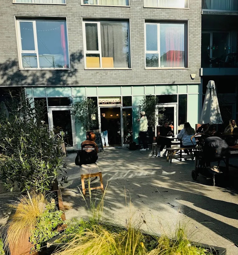 Popham restaurant patio with customers seated at tables.