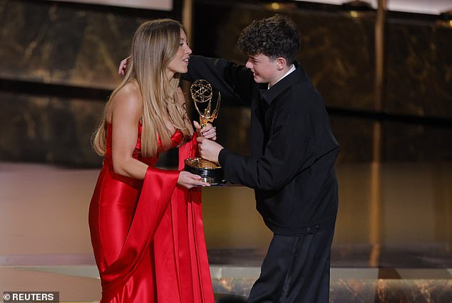 Owen Cooper accepts the award for Outstanding Supporting Actor in a Limited or Anthology Series or Movie for "Adolescence" from presenter Sydney Sweeney