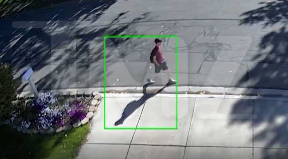 CCTV footage of a person walking on a sidewalk.