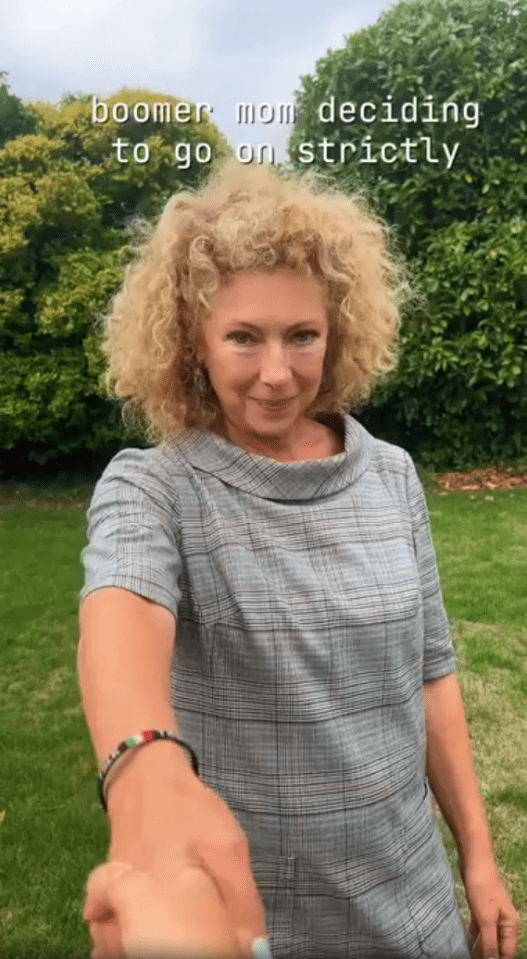 Woman in a gray dress considering participating in Strictly Come Dancing.