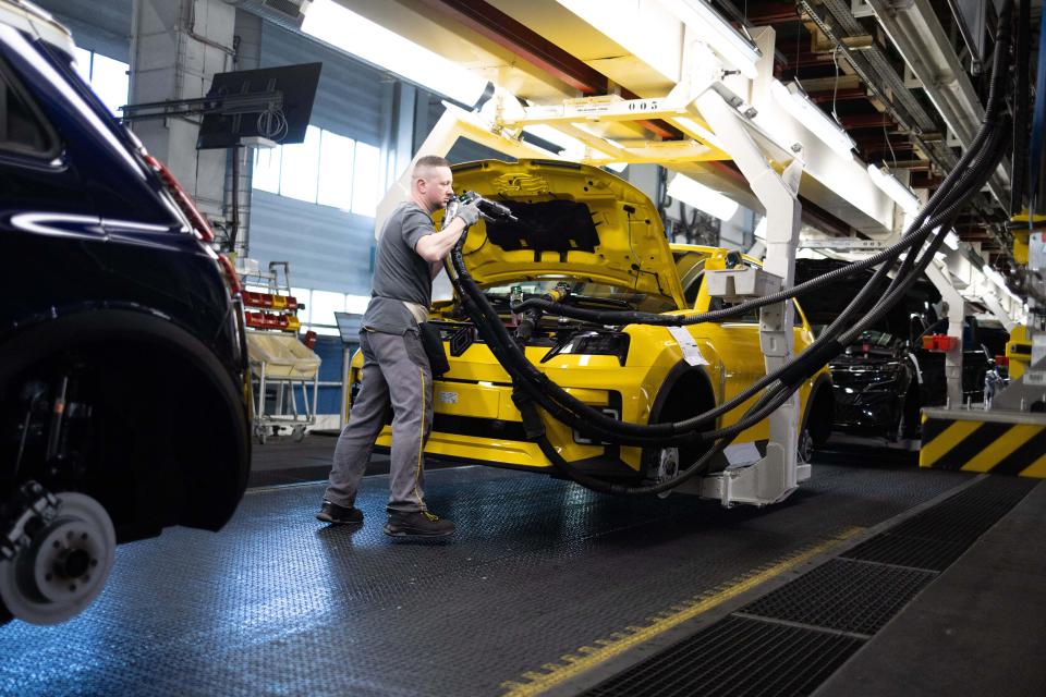 Worker on an automobile assembly line.