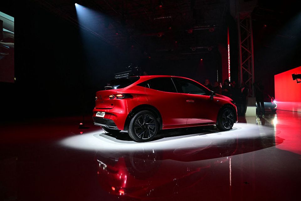 Rear view of a red Renault Clio full-hybrid car.