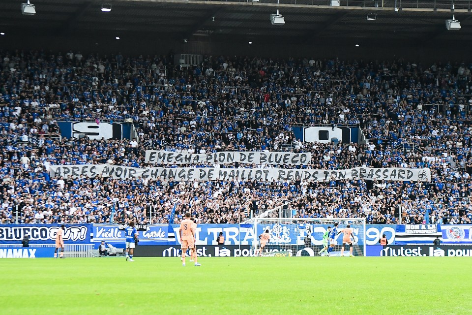 Strasbourg soccer fans holding a banner protesting a player.