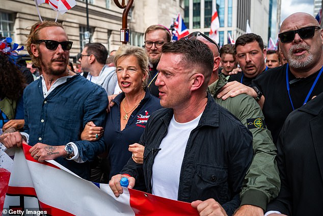 Tommy Robinson (right) seen carrying a banner alongside Katie Hopkins (centre) and former actor Laurence Fox (left)