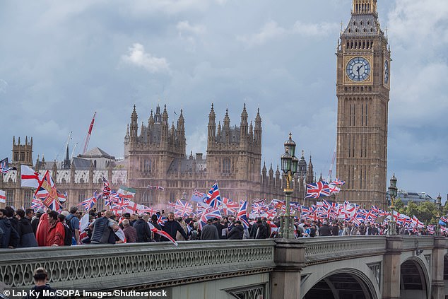 Patriots cross Westminster bridge holding aloft Union Flags during the rally on Saturday