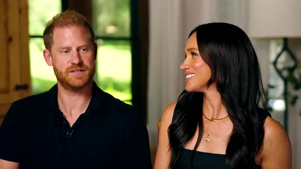 Prince Harry and Meghan Markle looking at each other while discussing their love for Disney.