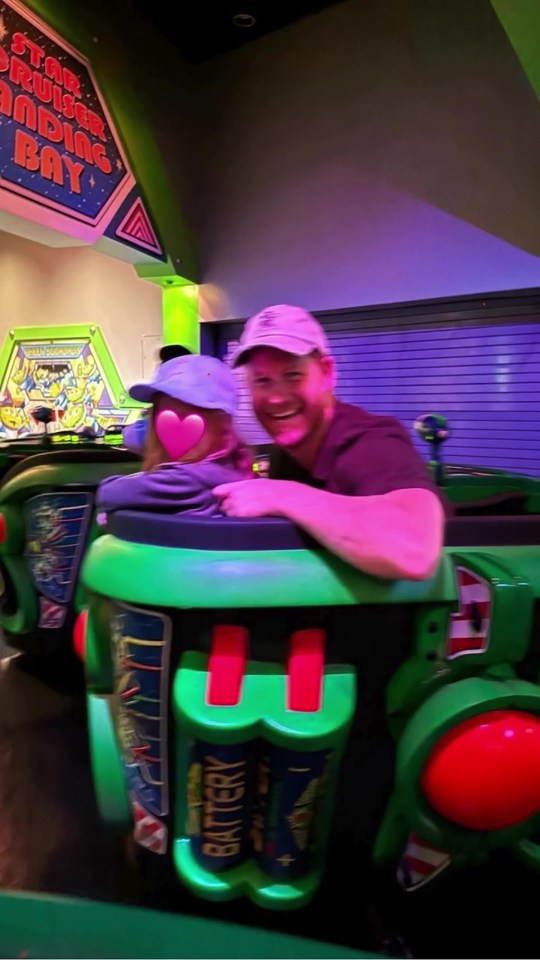 Prince Harry and a child on a Star Wars ride at Disneyland.