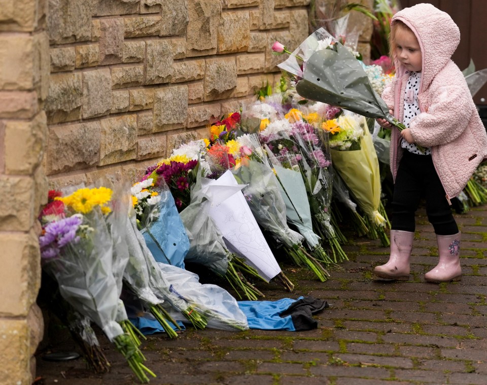 Taya Price, 2, lays a floral tribute in memory of Ricky Hatton.