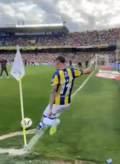 Angel Di Maria taking a corner kick in a soccer stadium.