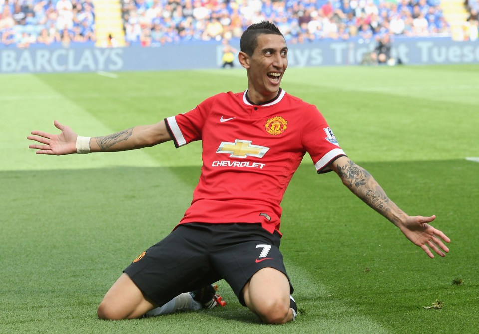 Angel di Maria on his knees in a red Manchester United uniform, arms outstretched, celebrating a goal.