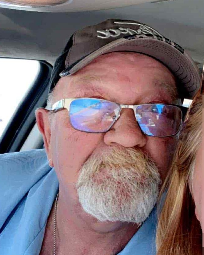 Photo of a man and a woman; the woman's face is pixelated.