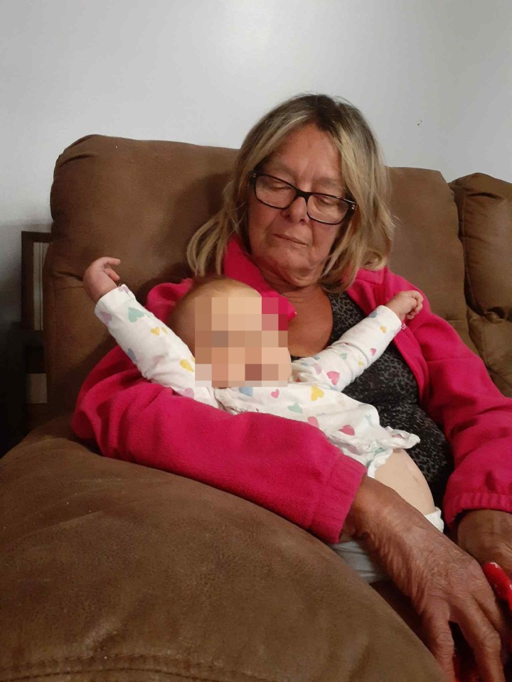 Woman holding a baby.
