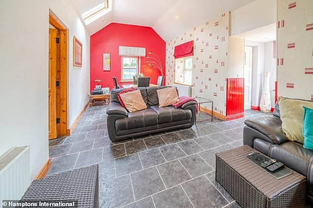 Sweeney's former home, a 900-square-foot bungalow, has an open plan living and dining area, with a traditional stone fireplace