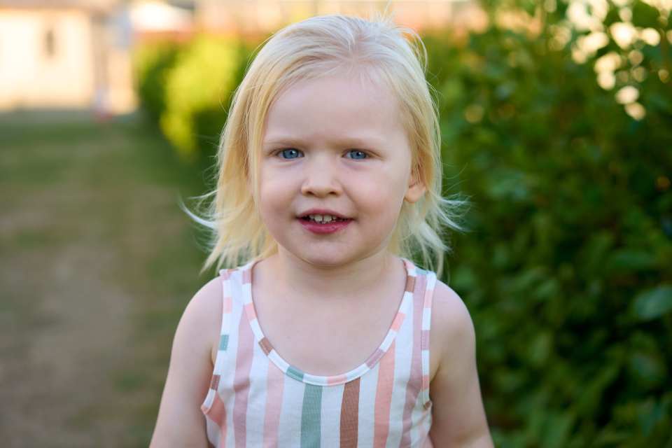 Rosie Bridge, a young girl with blonde hair and blue eyes, smiling.