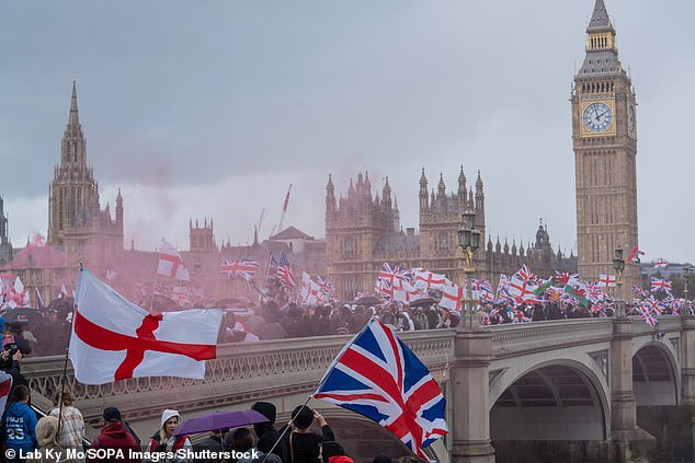 Tommy Robinson led a Unite the Kingdom march through central London that saw 150,000 protesters fly flags and air concerns about migrations and small boats