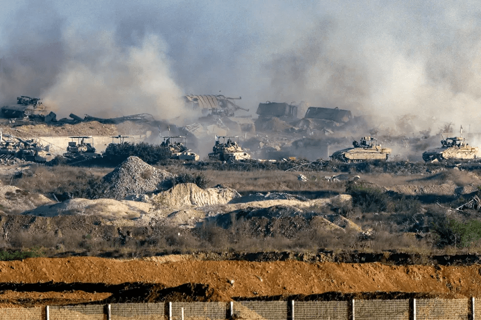 Tanks move through a smoke-filled, rubble-strewn landscape.