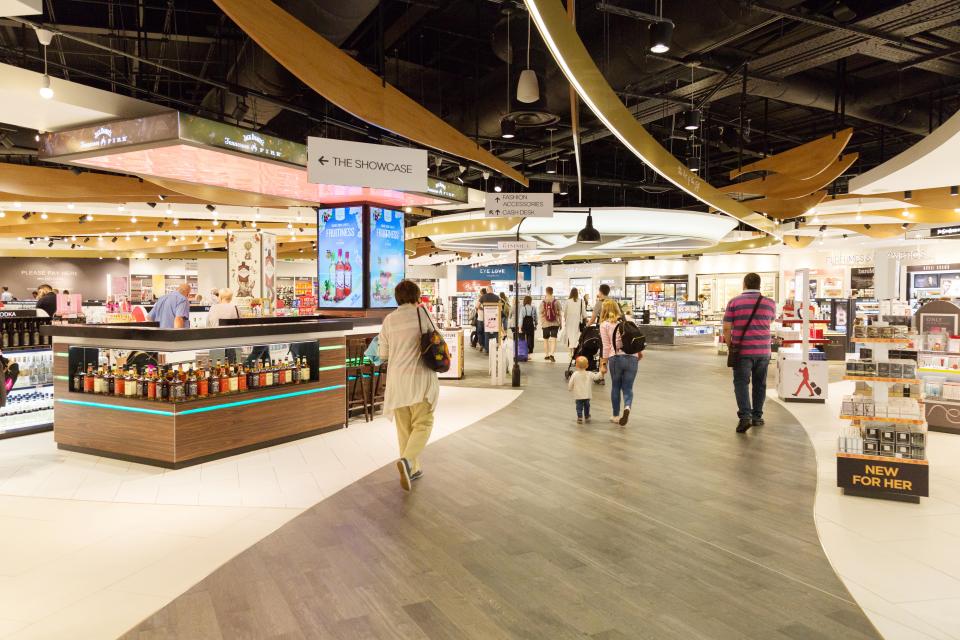 People walking through the Duty Free shop at Luton Airport.