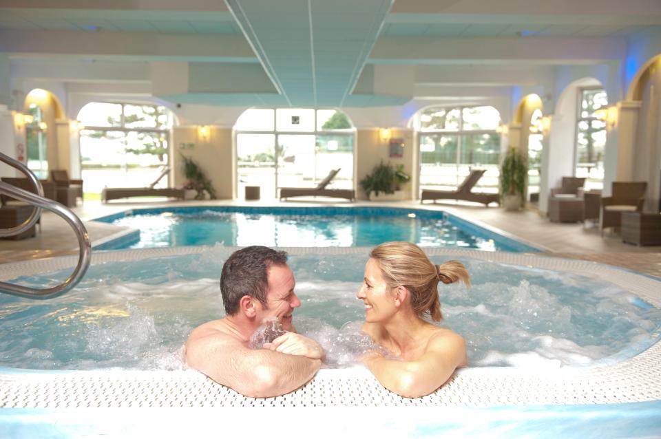 Couple relaxing in a hotel spa bath.