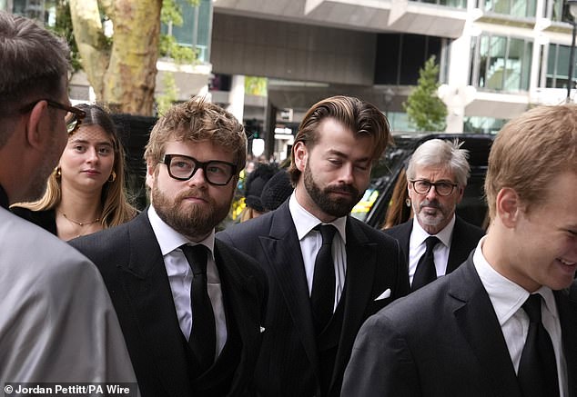 Pictured centre left to right: Columbus Taylor and Cassius Taylor arrive for the funeral service today