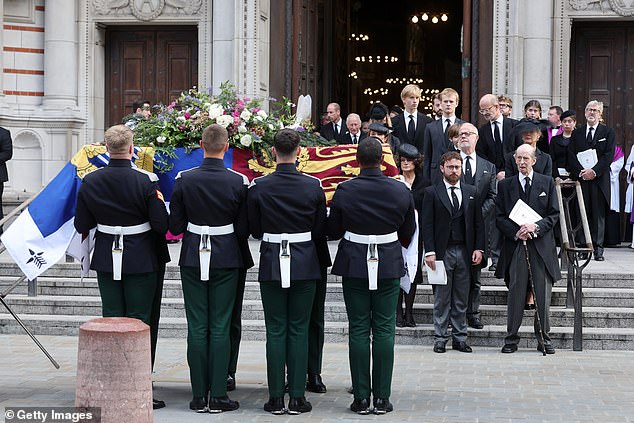 The coffin of the Duchess of Kent is carried out of Westminster Cathedral, as her widower Prince Edward watched over it