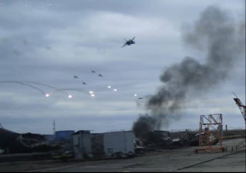 Ukrainian Sukhoi-24 M bomber attacking Hostomel airport with smoke from explosions in the foreground.