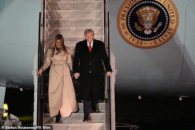 Donald Trump walks hand-in-hand with First Lady Melania as they descend the aircraft steps after landing at Stansted Airport