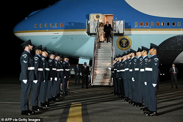 Trump and US First Lady Melania Trump disembark from Air Force One where the The King’s Colour Squadron from Royal Air Force lined up on the tarmac
