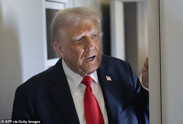 Trump is seen chatting to members of the press during his flight to Britain