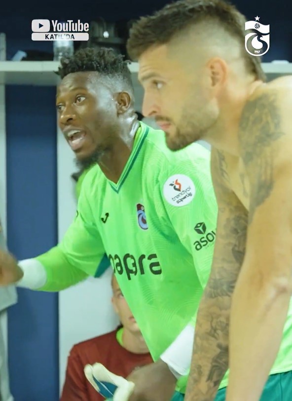 Andre Onana speaking to a teammate in the locker room.