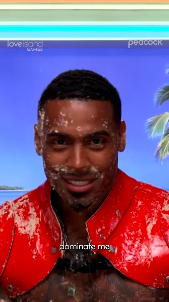 A man with a mess on his face and chest, wearing a red top, with text that reads "dominate me".