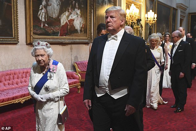 President Donald Trump (right) walks into the 2019 state banquet at Buckingham Palace alongside Queen Elizabeth II (left)