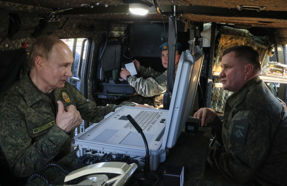 Russia's President Vladimir Putin inspects the "Zapad-2025" military drills in a vehicle with another man.