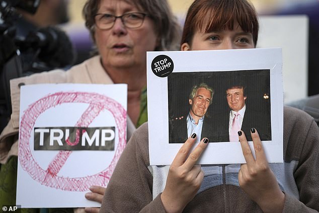 Protesters hold anti-Trump posters as they gather in Windsor on Tuesday