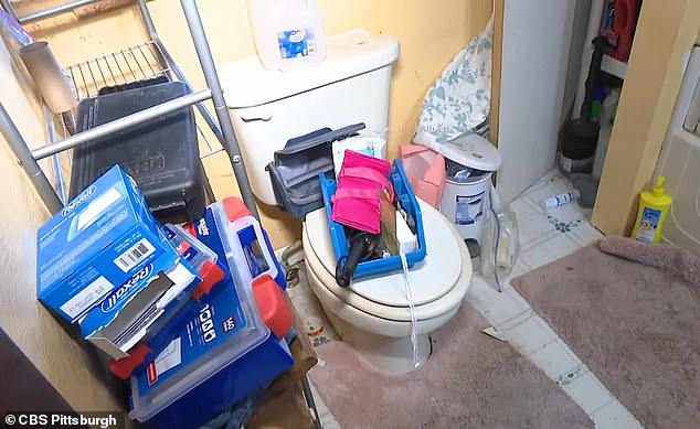 Police said Mauthe gave birth to all three children. She had the most recent one about a year ago in her bathroom while sitting on the toilet, according to court records (pictured: the house's toilet covered in clutter)