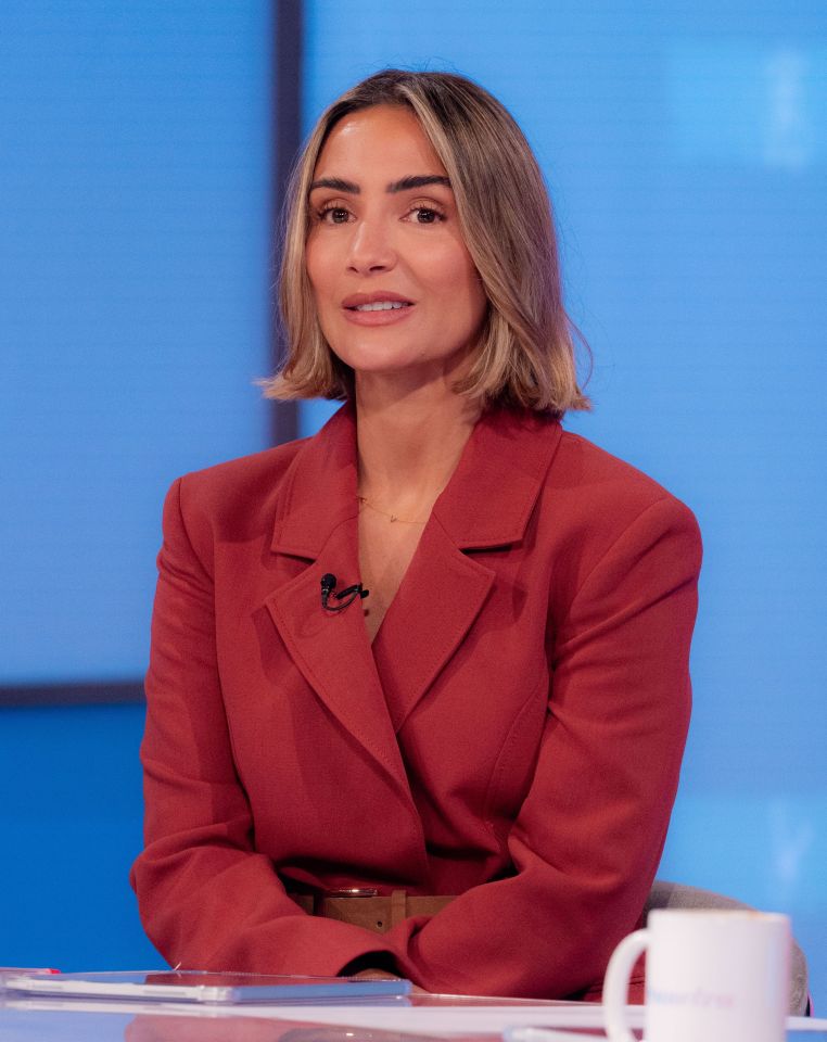 Frankie Bridge wearing a red blazer with a microphone clipped to her lapel, appearing on the "Loose Women" TV show.