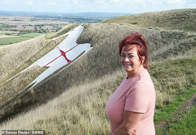 Pictured: Regular walker Velisa Russell next to the flag. The horse was first cut into the escarpment of Salisbury Plain in the late 17th century but was changed to the current iconic design in 1778