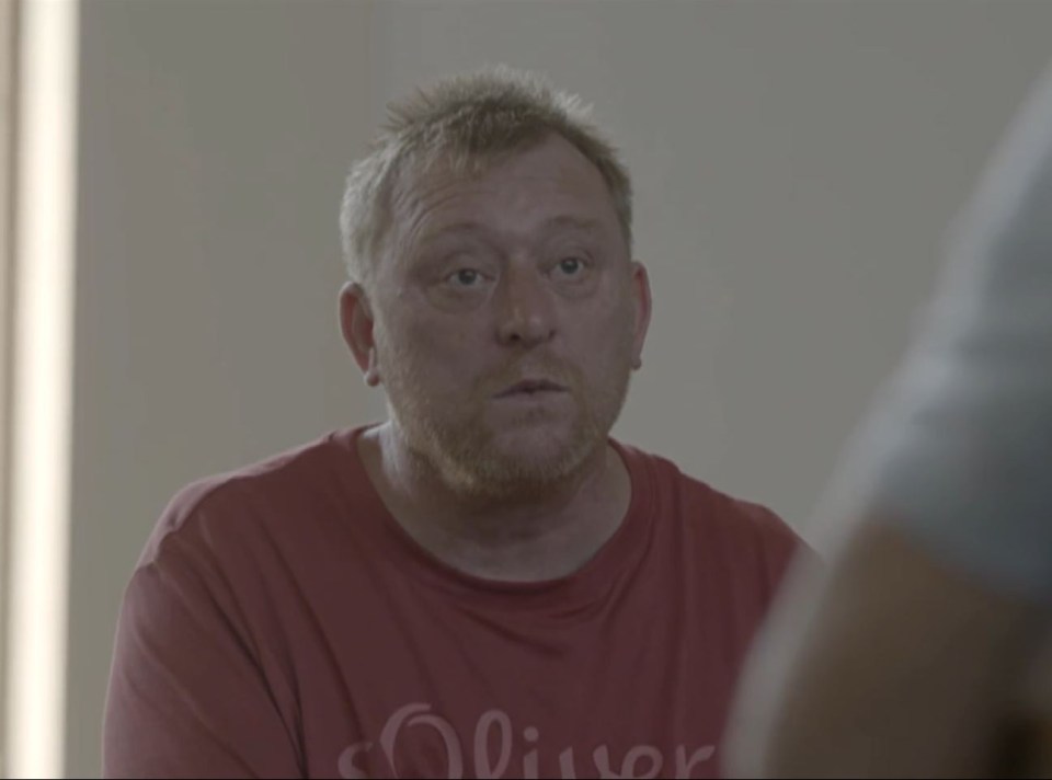 A man with a ginger beard wearing a red t-shirt.
